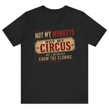 Load image into Gallery viewer, A black short-sleeve crewneck t-shirt with a vintage-style circus-themed graphic on the chest. The graphic features the text 'NOT MY MONKEYS NOT MY CIRCUS BUT I DEFINITELY KNOW THE CLOWNS' in distressed red and beige fonts.
